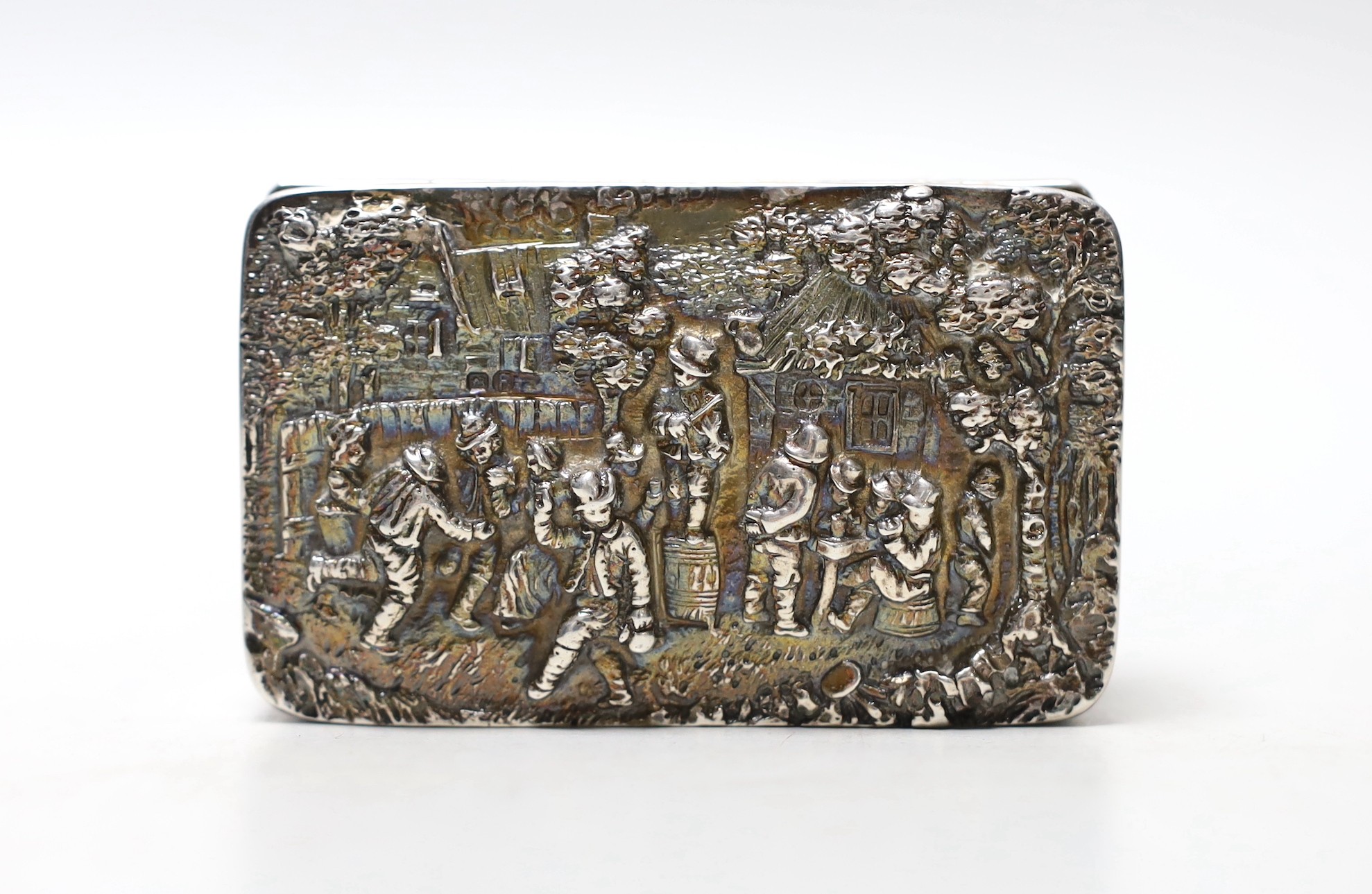 An early 20th century Hanau silver rectangular box, embossed with revellers, import marks for Sheffield, 1900, 87mm.